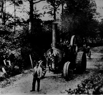 Steam traction-engine Hero preceded by a man with a red flag